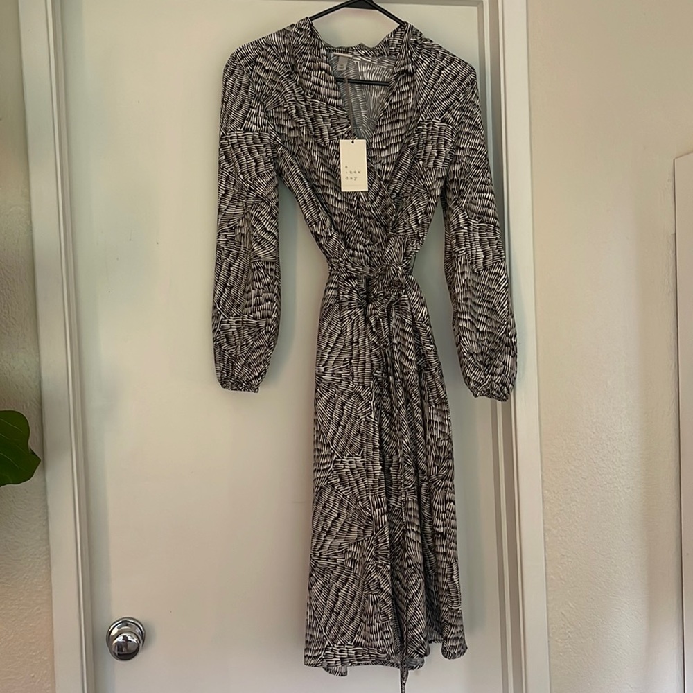 Brand new with tags, classy long sleeve with slit in side.